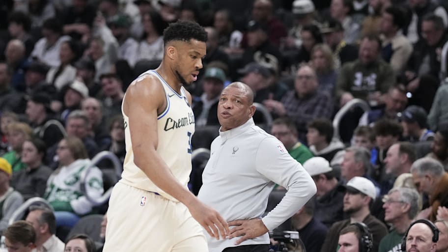 Milwaukee Bucks forward Giannis Antetokounmpo comes out of the game and walks past coach Doc Rivers.