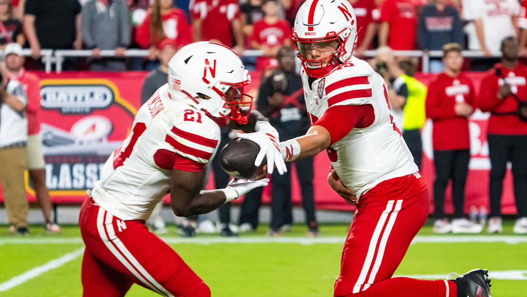 Dylan Raiola hands off to Emmett Johnson during the Huskers' season opener against Cincinnati.