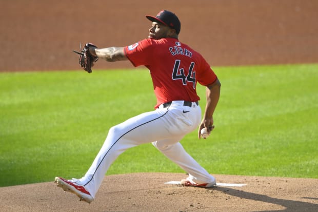 Xzavion Curry winds up and throws a pitch 