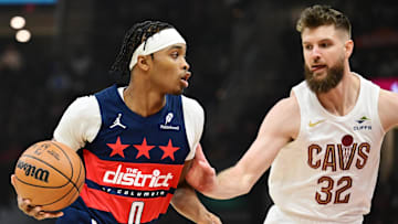 Dec 13, 2024; Cleveland, Ohio, USA; Washington Wizards guard Bilal Coulibaly (0) drives to the basket against Cleveland Cavaliers forward Dean Wade (32) during the first quarter at Rocket Mortgage FieldHouse. Mandatory Credit: Ken Blaze-Imagn Images
