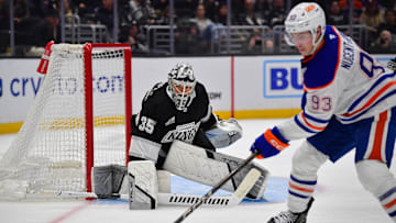 Dec 28, 2024; Los Angeles, California, USA; Los Angeles Kings goaltender Darcy Kuemper (35) defends the goal against Edmonton Oilers center Ryan Nugent-Hopkins (93) during the third period at Crypto.com Arena. Mandatory Credit: Gary A. Vasquez-Imagn Images