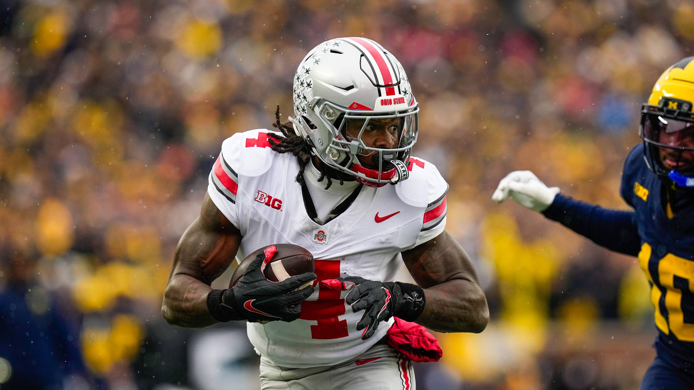 Ohio State Buckeyes wide receiver Jeremiah Smith (4) runs the ball in for a touchdown against the Michigna Wolverines in the first half of the NCAA football game at Michigan Stadium on Saturday, Nov. 29, 2025 in Ann Arbor, Michigan.