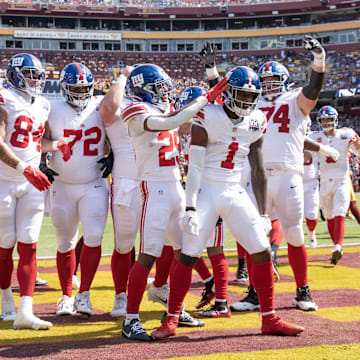 Sep 15, 2024; Landover, Maryland, USA; New York Giants wide receiver Malik Nabers (1) celebrates with teammates after catching a touchdown pass in the first half against the Washington Commanders at Commanders Field. 