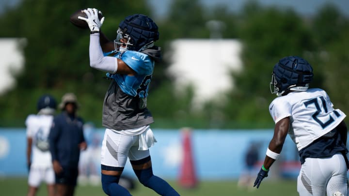 Tennessee Titans wide receiver Tyler Boyd (83) makes a catch ahead of cornerback Roger McCreary (21) during the Tennessee Titans training camp at Ascension Saint Thomas Sports Park in Nashville, Tenn., Tuesday, July 30, 2024.