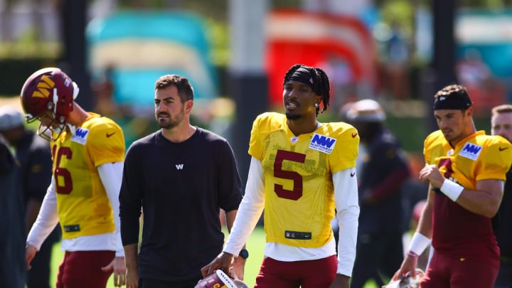 Aug 15, 2024; Miami Gardens, FL, USA; Washington Commanders quarterback Jayden Daniels (5) looks on during joint practice with the Miami Dolphins at Baptist Health Training Complex. Mandatory Credit: Sam Navarro-USA TODAY Sports