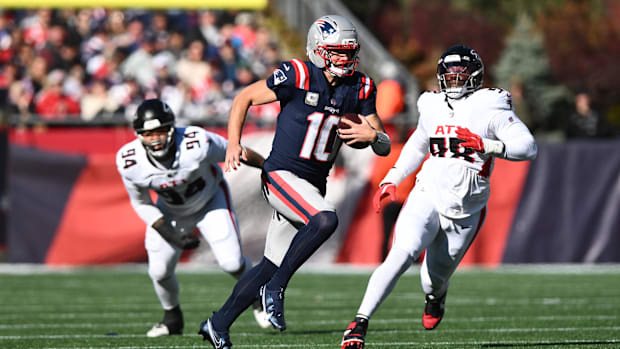 New England Patriots quarterback Drake Maye (10) scrambles with the ball. New England Patriots quarterback Drake Maye (10) scrambles with the ball.