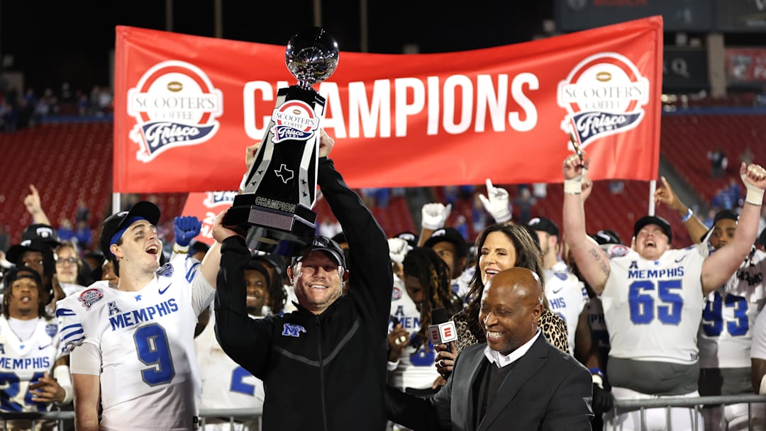 Dec 17, 2024; Frisco, TX, USA; Memphis Tigers head coach Ryan Silverfield holds up the trophy after winning the game against the West Virginia Mountaineers at Toyota Stadium. Mandatory Credit: Tim Heitman-Imagn Images
