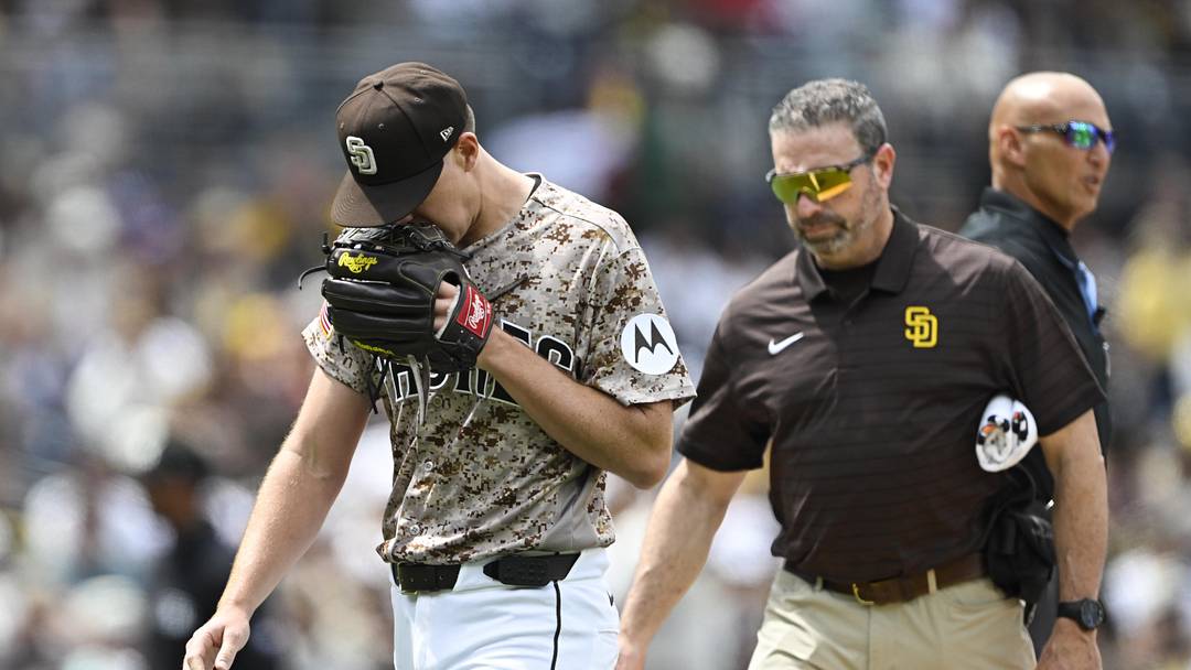Apr 12, 2026; San Diego, California, USA; San Diego Padres starting pitcher Nick Pivetta (27), left, leaves the field with a trainer during the fourth inning against the Colorado Rockies at Petco Park. Mandatory Credit: Denis Poroy-Imagn Images