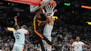 Dec 19, 2024; San Antonio, Texas, USA;  Atlanta Hawks forward De'Andre Hunter (12) dunks over San Antonio Spurs center Victor Wembanyama (1) in the second half at Frost Bank Center. Mandatory Credit: Daniel Dunn-Imagn Images