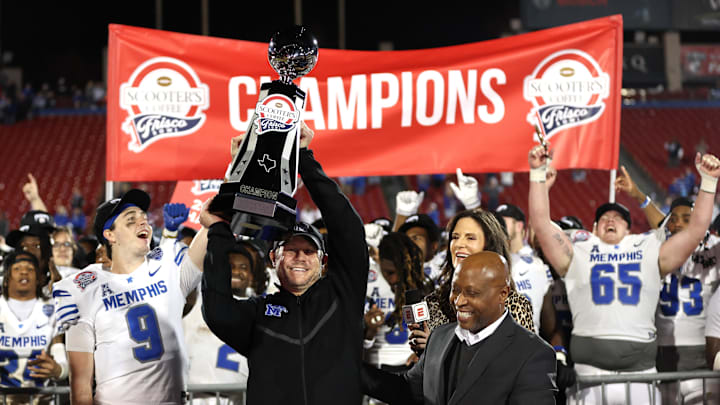 Dec 17, 2024; Frisco, TX, USA; Memphis Tigers head coach Ryan Silverfield holds up the trophy after winning the game against the West Virginia Mountaineers at Toyota Stadium. Mandatory Credit: Tim Heitman-Imagn Images
