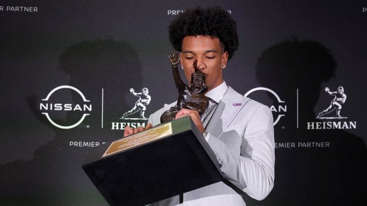 Dec 9, 2023; New York, New York, USA; LSU Tigers quarterback Jayden Daniels kisses the Heisman trophy during a press conference in the Astor ballroom at the New York Marriott Marquis after winning the Heisman trophy. Mandatory Credit: Brad Penner-USA TODAY Sports