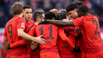 Bayern Munich players celebrating against Holstein Kiel.