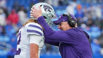 Oct 25, 2025; Lawrence, Kansas, USA; Kansas State Wildcats head coach Chris Klieman congratulates quarterback Avery Johnson (2) after he scores against the Kansas Jayhawks during the second half of the game at David Booth Kansas Memorial Stadium. Mandatory Credit: Denny Medley-Imagn Images