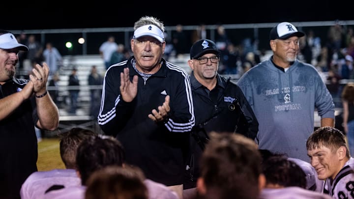 Robbinsville head coach, Dee Walsh, huddles with his team following their win at Murphy, October 6, 2023.