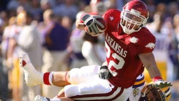 Former Arkansas fullback Peyton Hillis braces himself while being tackled in an upset of LSU. The Razorbacks expect to bring the position back for the 2024 season.