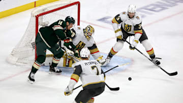 Apr 26, 2025; Saint Paul, Minnesota, USA; Minnesota Wild center Joel Eriksson Ek (14) looks for a loose puck in front of Vegas Golden Knights goaltender Adin Hill (33) during 1st OT in game four of the first round of the 2025 Stanley Cup Playoffs at Xcel Energy Center. Mandatory Credit: Bruce Fedyck-Imagn Images