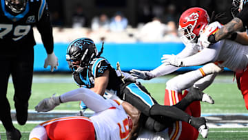 Nov 24, 2024; Charlotte, North Carolina, USA; Carolina Panthers running back Jonathon Brooks (24) is tackled by Kansas City Chiefs linebacker Nick Bolton (32) in the second quarter at Bank of America Stadium. Mandatory Credit: Bob Donnan-Imagn Images