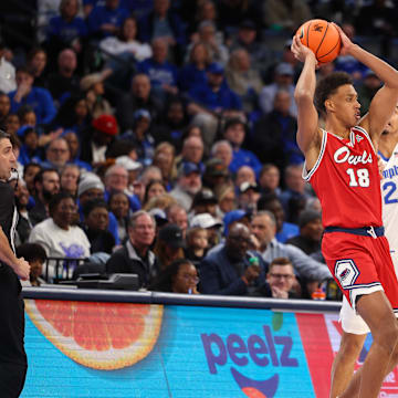 Feb 23, 2025; Memphis, Tennessee, USA; Florida Atlantic Owls forward Baba Miller (18) looks to pass against Memphis Tigers guard Tyrese Hunter (11) during the first half at FedExForum. Mandatory Credit: Wesley Hale-Imagn Images