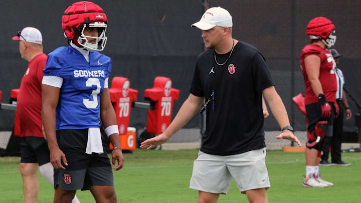 Oklahoma offensive coordinator Ben Arbuckle works with quarterback Michael Hawkins Jr. at practice. Oklahoma offensive coordinator Ben Arbuckle works with quarterback Michael Hawkins Jr. at practice.
