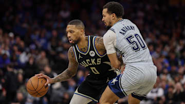Milwaukee Bucks guard Damian Lillard is guarded by Orlando Magic guard Cole Anthony in the in the second quarter at Kia Center on Friday.