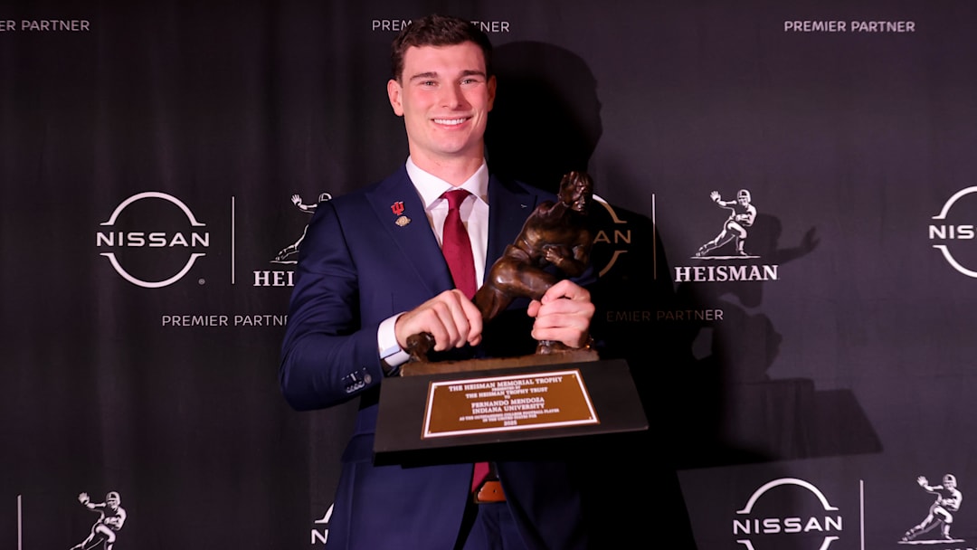 Dec 13, 2025; New York, NY, USA; Indiana Hoosiers quarterback Fernando Mendoza poses for photos with the Heisman trophy during a press conference at the New York Marriott Marquis after winning the award. Mandatory Credit: Brad Penner-Imagn Images