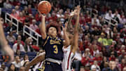 Mar 10, 2024; Greensboro, NC, USA; Notre Dame Fighting Irish guard Hannah Hidalgo (3) shoots the ball ahead of NC State Wolfpack guard Aziaha James (10) during the second half at Greensboro Coliseum. Mandatory Credit: David Yeazell-Imagn Images