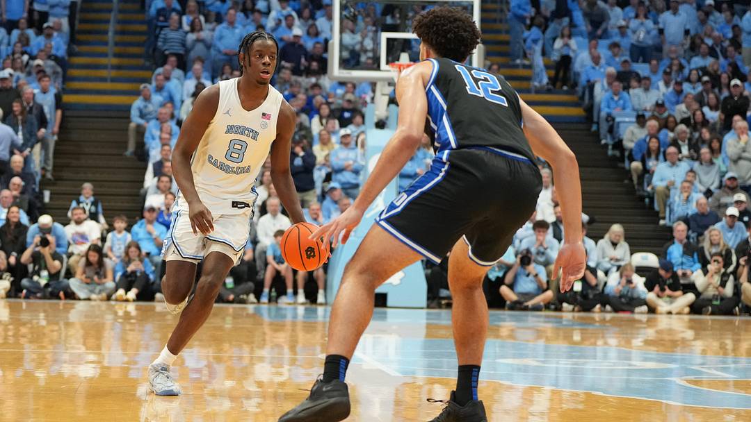 Feb 7, 2026; Chapel Hill, North Carolina, USA; North Carolina Tar Heels forward Caleb Wilson (8) with the ball as Duke Blue Devils forward Cameron Boozer (12) defends in the second half at Dean E. Smith Center. Mandatory Credit: Bob Donnan-Imagn Images