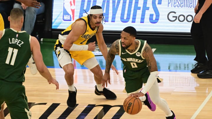 Milwaukee Bucks guard Damian Lillard (0) drives for the basket against Indiana Pacers guard Andrew Nembhard (2) in the first quarter during game one of the first round for the 2024 NBA playoffs at Fiserv Forum. 