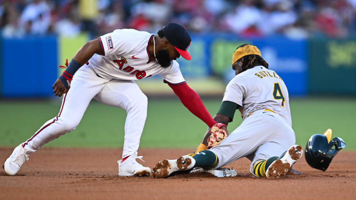 Jul 27, 2024; Anaheim, California, USA; Oakland Athletics outfielder Lawrence Butler (4) steals second base against Los Angeles Angels second baseman Luis Rengifo (2) during the first inning at Angel Stadium. Mandatory Credit: Jonathan Hui-USA TODAY Sports