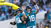 Nov 16, 2025; Jacksonville, Florida, USA; Jacksonville Jaguars quarterback Trevor Lawrence (16) celebrates with offensive tackle Cole Van Lanen (70) after rushing for a touchdown against the Los Angeles Chargers during the third quarter at EverBank Stadium. Mandatory Credit: Morgan Tencza-Imagn Images