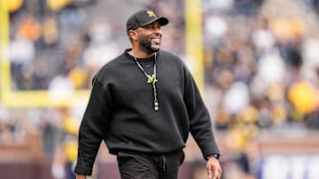 Michigan head coach Sherrone Moore smiles at players as he watches the first half of the spring game at Michigan Stadium in Ann Arbor on Saturday, April 19, 2025.