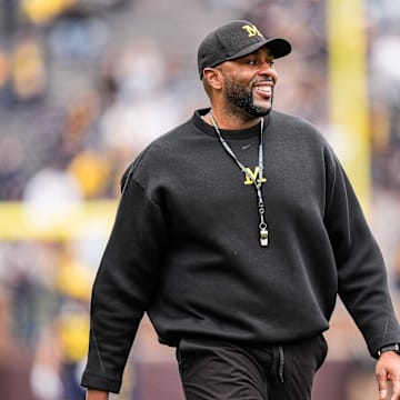 Michigan head coach Sherrone Moore smiles at players as he watches the first half of the spring game at Michigan Stadium in Ann Arbor on Saturday, April 19, 2025.