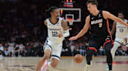 Apr 3, 2025; Miami, Florida, USA; Memphis Grizzlies guard Ja Morant (12) passes the basketball as Miami Heat guard Pelle Larsson (9) defends during the second quarter at Kaseya Center. Mandatory Credit: Sam Navarro-Imagn Images