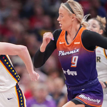 Indiana Fever guard Caitlin Clark (22) rushes up the court against Phoenix Mercury guard Sophie Cunningham (9) on Friday, July 12, 2024, during the game at Gainbridge Fieldhouse in Indianapolis.