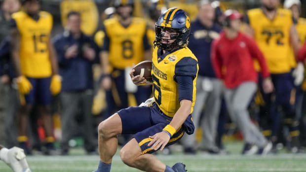 West Virginia Mountaineers quarterback Garrett Greene (6) begins his slide. Jim Dedmon-USA TODAY Sports