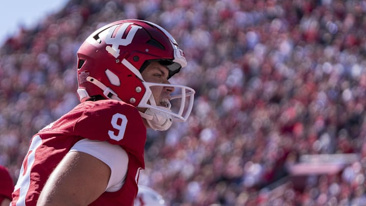 Oct 19, 2024; Bloomington, Indiana, USA; Indiana Hoosiers quarterback Kurtis Rourke (9) celebrates throwing a touchdown pass during the second quarter of a game against the Nebraska Cornhuskers at Memorial Stadium. Mandatory Credit: Jacob Musselman-Imagn Images