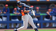 Feb 27, 2025; Port St. Lucie, Florida, USA; Houston Astros third baseman Cam Smith (90) hits a single against the New York Mets during the fourth inning at Clover Park. 