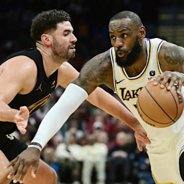 Nov 25, 2023; Cleveland, Ohio, USA; Los Angeles Lakers forward LeBron James (23) drives to the basket against Cleveland Cavaliers forward Georges Niang (20) during the second half at Rocket Mortgage FieldHouse. Mandatory Credit: Ken Blaze-Imagn Images