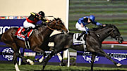 Nov 2, 2024; Del Mar, CA, USA; Rebel’s Romance ridden by William Buick wins the Turf race ahead of Rousham Park ridden by Christophe Lemaire during the 2024 Breeders' Cup Championship at Del Mar Thoroughbred Club. 