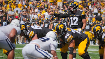 Iowa Hawkeyes quarterback Cade McNamara (12) leads the offense as the Hawkeyes take on Utah State at Kinnick Stadium in Iowa City, Saturday, Sept. 2, 2023.
