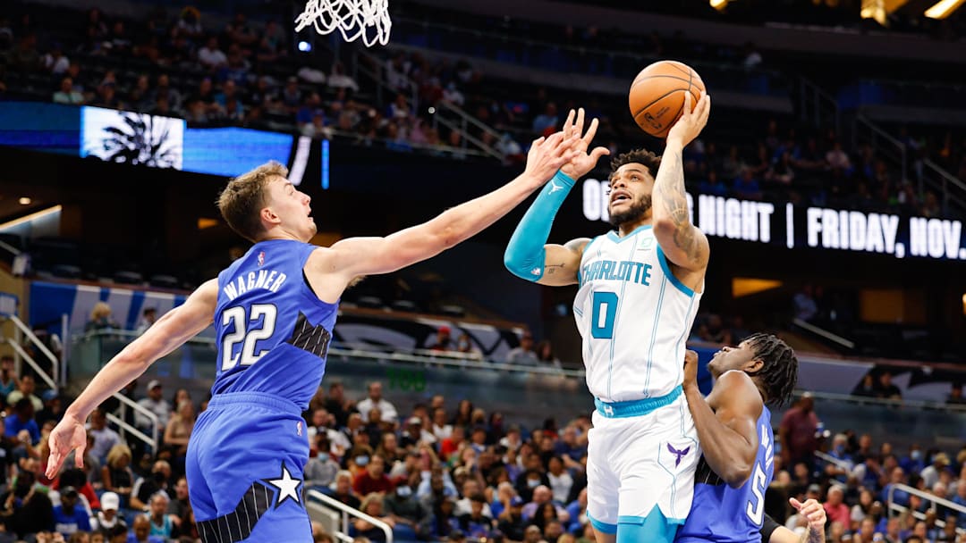Charlotte Hornets forward Miles Bridges (0) shoots over Orlando Magic forward Franz Wagner 