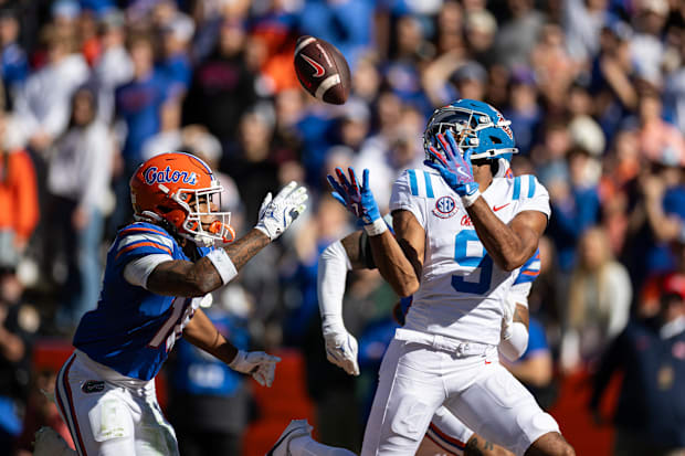 Ole Miss WR Tre Harris makes a catch for a touchdown over Florida Gators defensive back Bryce Thornton.