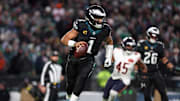 Nov 28, 2025; Philadelphia, Pennsylvania, USA; Philadelphia Eagles quarterback Jalen Hurts (1) scrambles with the ball against the Chicago Bears during the third quarter of the game at Lincoln Financial Field. Mandatory Credit: Bill Streicher-Imagn Images