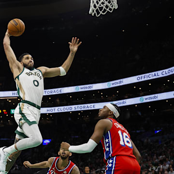 Feb 27, 2024; Boston, Massachusetts, USA; Boston Celtics forward Jayson Tatum (0) goes in for a dunk as Philadelphia 76ers forward Darius Bazley (25) and guard Ricky Council IV (16) look on during the second half at TD Garden. Mandatory Credit: Winslow Townson-Imagn Images