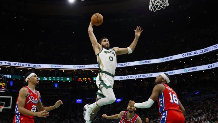 Feb 27, 2024; Boston, Massachusetts, USA; Boston Celtics forward Jayson Tatum (0) goes in for a dunk as Philadelphia 76ers forward Darius Bazley (25) and guard Ricky Council IV (16) look on during the second half at TD Garden. Mandatory Credit: Winslow Townson-USA TODAY Sports
