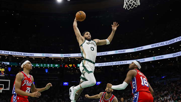 Feb 27, 2024; Boston, Massachusetts, USA; Boston Celtics forward Jayson Tatum (0) goes in for a dunk as Philadelphia 76ers forward Darius Bazley (25) and guard Ricky Council IV (16) look on during the second half at TD Garden. Mandatory Credit: Winslow Townson-Imagn Images