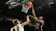 Jan 15, 2025; Boulder, Colorado, USA; Cincinnati Bearcats forward Arrinten Page (22) shoots over Colorado Buffaloes forward Trevor Baskin (6) in the first half at the CU Events Center. Mandatory Credit: Ron Chenoy-Imagn Images