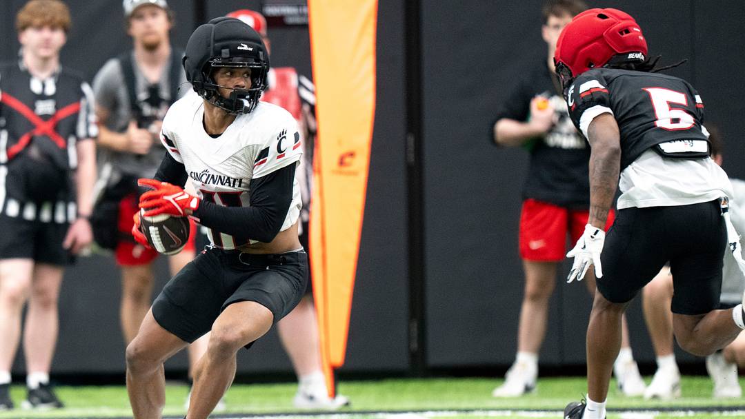Cincinnati Bearcats wide receiver JV Gibson (11) catches a pass as Cincinnati Bearcats linebacker Marquavious Sabor (5) guards him during the Cincinnati Bearcats Spring Showcase in Cincinnati on Saturday, April 18, 2026.