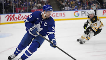 Jan 4, 2025; Toronto, Ontario, CAN; Toronto Maple Leafs forward Auston Matthews (34) carries the puck as Boston Bruins forward Brad Marchand (63) closes in during the second period at Scotiabank Arena. Mandatory Credit: John E. Sokolowski-Imagn Images