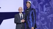 Penn State's Yanic Konan Niederhauser stands with NBA commissioner Adam Silver after being selected as the 30th pick by the Los Angeles Clippers in the first round of the 2025 NBA Draft. 
